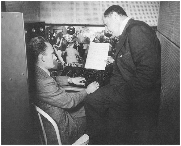 George Groves in a portable mixer booth with composer Sigmund Romberg