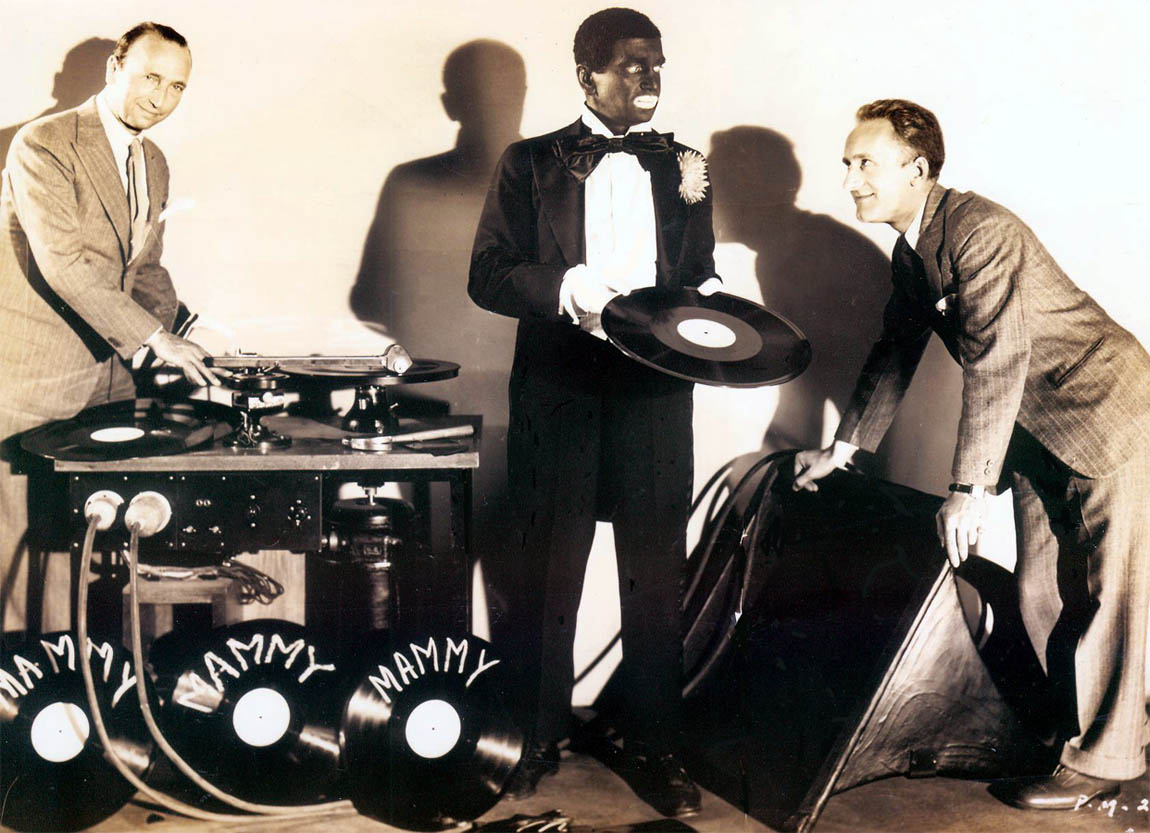 Al Jolson and George Groves posing with Mammy playback turntables Al Jolson and George Groves posing with Mammy playback turntables