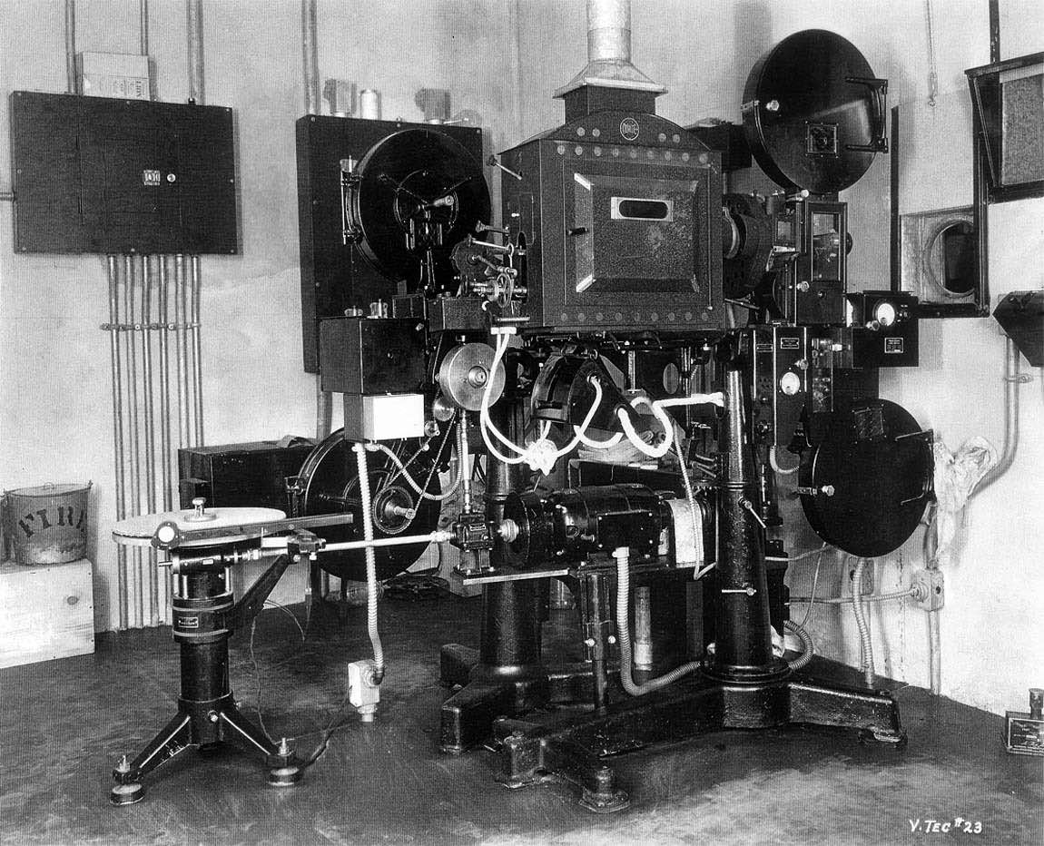 1931 photo of review room projector with disc attachment and sound film reproducer 1931 photo of review room projector with disc attachment and sound film reproducer