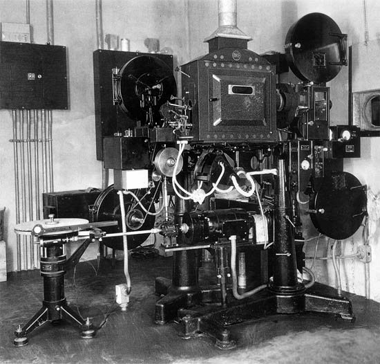1931 photo of review room projector with disc attachment and sound film reproducer 1931 photo of review room projector with disc attachment and sound film reproducer
