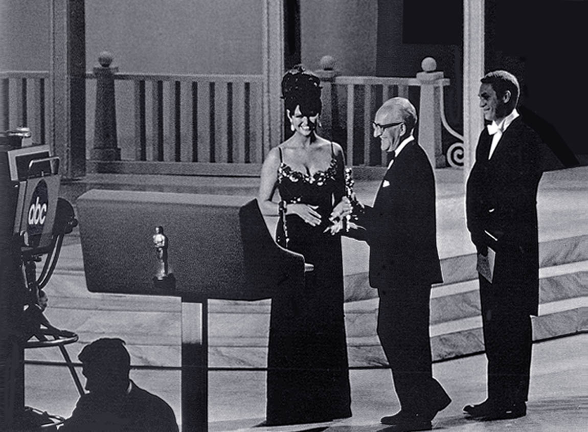 George Groves receiving a Best Sound Oscar from Claudia Cardinale and Steve McQueen at the 1965 Academy Awards George Groves receiving a Best Sound Oscar from Claudia Cardinale and Steve McQueen at the 1965 Academy Awards